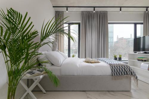 En eller flere senge i et værelse på Centro Design Apartments - Półwiejska