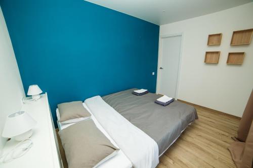 una camera blu con un letto con due libri sopra di TF Apartment двокімнатні апартаменти в центрі міста a Poltava