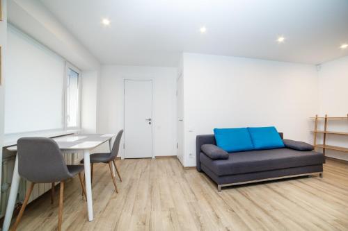 a living room with a couch and a table at TF Apartment двокімнатні апартаменти в центрі міста in Poltava