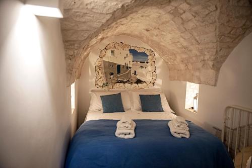 a bedroom with a bed with towels on it at Liberty Bell in Ostuni