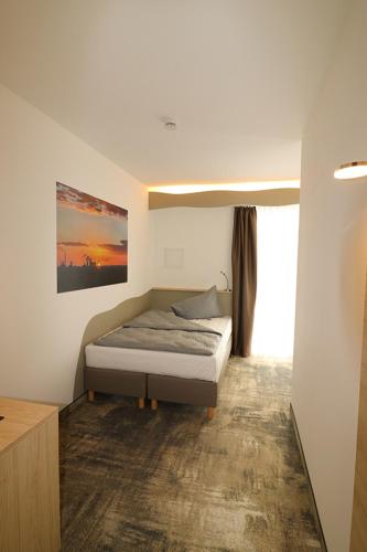 Una cama o camas en una habitación de Petul Apart Hotel An'ne 40