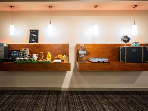 a waiting room with a counter and shelves with luggage at Novotel Reading Centre in Reading