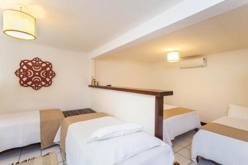 Ένα ή περισσότερα κρεβάτια σε δωμάτιο στο Hotel Pousada Coqueiros