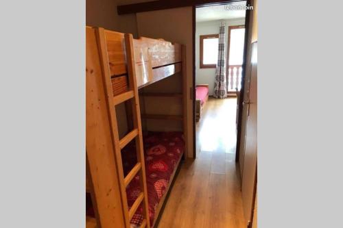 a bunk bed in a room with a bunk bed in a house at Studio 50 m du funiculaire et pistes in Tignes