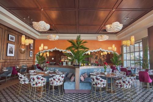 a restaurant with tables and chairs in a room at Bahia Principe Grand Bavaro - All Inclusive in Punta Cana