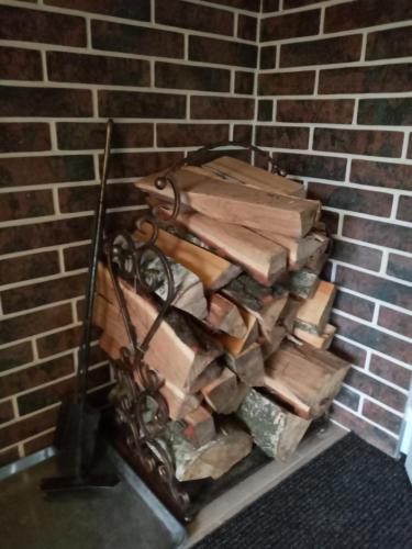 a pile of wood on a shelf in a brick wall at Hotel and Restaurant Complex Lubokray in Pereiaslav-Khmelnytskyi