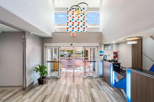 an empty lobby of a hospital with a clock on the ceiling at Clarion Pointe Madison-Huntsville in Madison