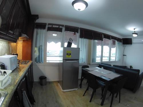 a kitchen and dining room with a table and chairs at Hotel Discovery in Santo Domingo