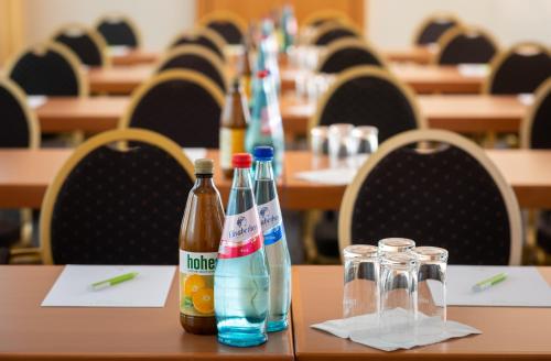 a long table with bottles of drinks on it at Parkhotel am Taunus in Oberursel