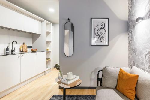 a living room with a couch and a table at ipartment Frankfurt Airport in Frankfurt/Main