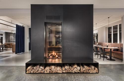 a fireplace in a living room with a pile of logs at Domizil Tübingen in Tübingen