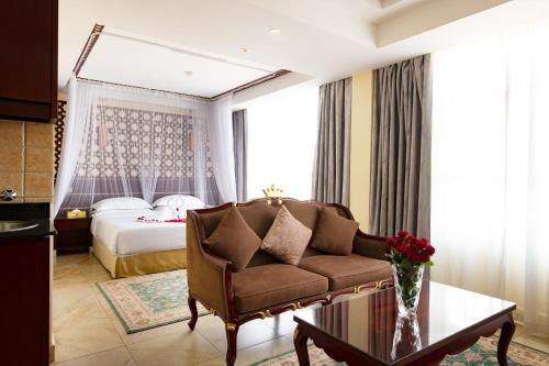 a living room with a couch and a bed at Saab Royale Hotel in Nairobi