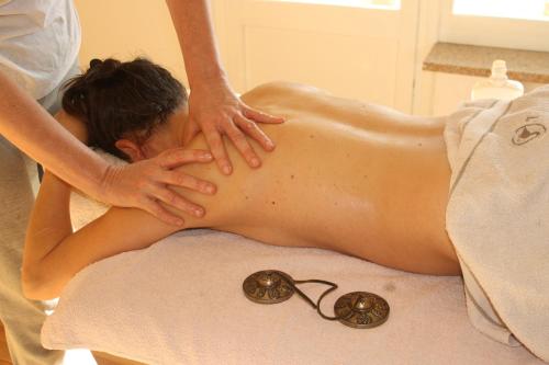 a woman getting a massage in a towel at Agriturismo Badalone in Domaso