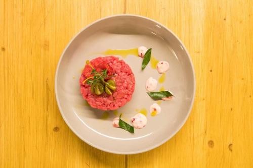 a plate of food on a wooden table at Maison La Saxe in Courmayeur