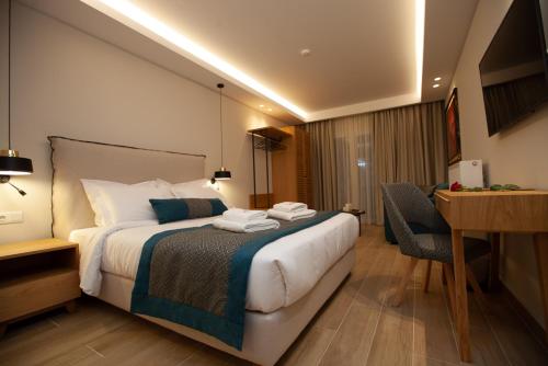 a hotel room with a bed and a desk at No21 Luxury Suites in Thessaloniki