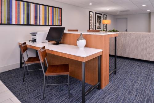 an office with a desk with a computer on it at Holiday Inn Express Hotel & Suites Elgin by IHG in Elgin