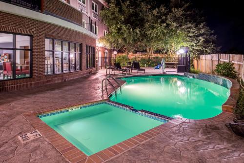 a swimming pool at night in front of a building at Holiday Inn Express Hotel & Suites Elgin by IHG in Elgin
