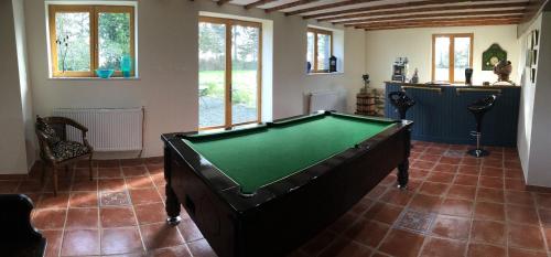 a pool table in the middle of a room at The Magnolias B&B in Moyon