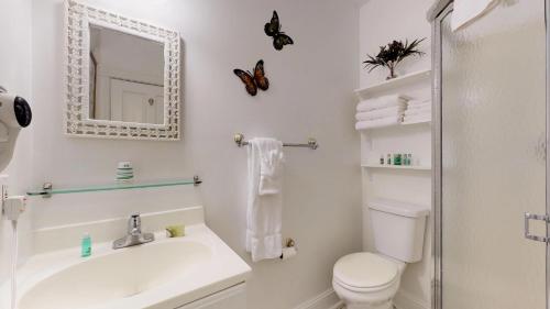 a bathroom with a sink and a toilet and a mirror at The Ocean Plaza Hotel in Ocean Grove