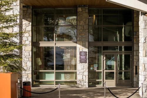 an entrance to a building with glass doors at Residence l Hevana - maeva Home in Méribel