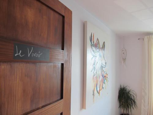 a door with a painting of a deer on the wall at Gîte B&B - Aubergélit inc in Saint-Jean-Port-Joli