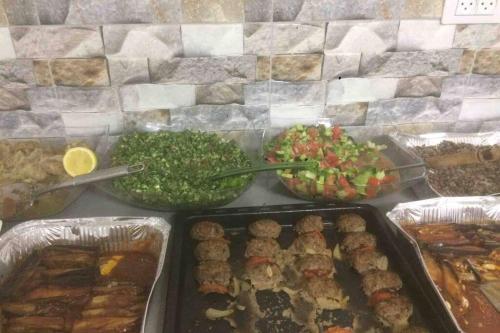 a buffet with different types of food on a table at Wonderful near Ram lake and Hermon mountain in Mas'ade