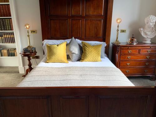 a bedroom with a large bed with yellow pillows at 23 Mayfield in Edinburgh