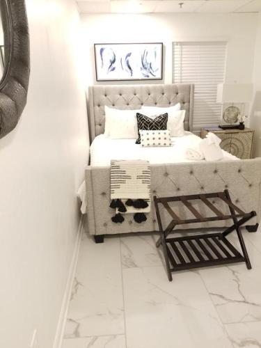 a white bedroom with a bed and a couch at 7 BR- Sleeps 15! Famous Lakefront Amazing Property! in New Orleans