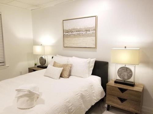 a bedroom with a white bed with two night stands at 7 BR- Sleeps 15! Famous Lakefront Amazing Property! in New Orleans