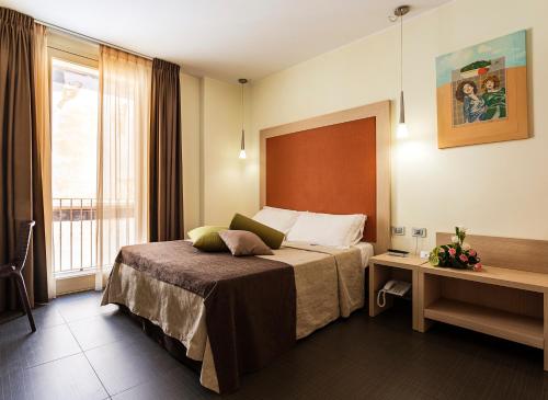 מיטה או מיטות בחדר ב-Hotel 33 Baroni