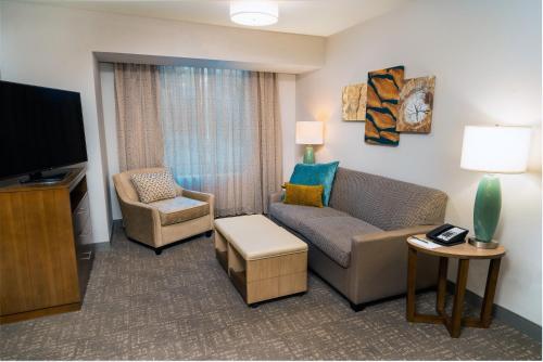 a living room with a couch and a tv at Staybridge Suites Coeur d'Alene by IHG in Coeur d'Alene