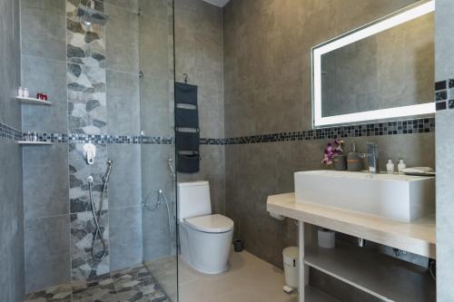 a bathroom with a toilet and a sink and a shower at Paradise Villa Eden in Bophut 