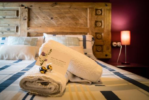 a hotel room with a bed with towels on it at Casa Rural Molí de Fòrnols in Fornols