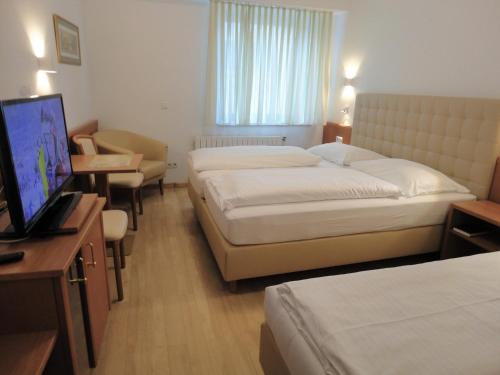 Un ou plusieurs lits dans un hébergement de l'établissement City Hotel Albrecht