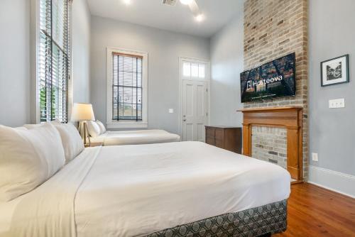 a bedroom with a bed and a fireplace at Cozy and Charming House Close to St Charles Ave in New Orleans