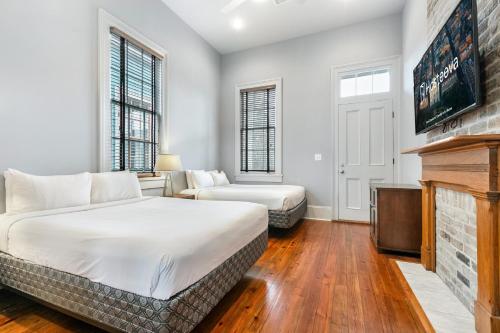 a bedroom with a bed and a fireplace at Cozy and Charming House Close to St Charles Ave in New Orleans