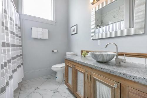a bathroom with a sink and a toilet at Cozy and Charming House Close to St Charles Ave in New Orleans