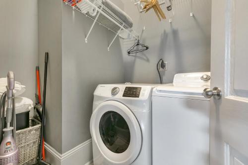a laundry room with a washing machine in it at Cozy and Charming House Close to St Charles Ave in New Orleans