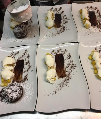 a row of white plates filled with chocolate desserts at Hotel-Restaurant Zum Onkel Jonathan in Raeren