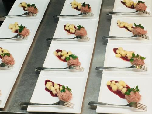 a row of plates of food on a table at Hotel-Restaurant Zum Onkel Jonathan in Raeren