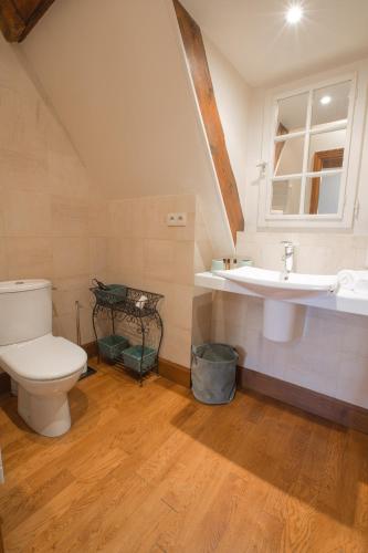 a bathroom with a toilet and a sink at La Tonnellerie in Beaune