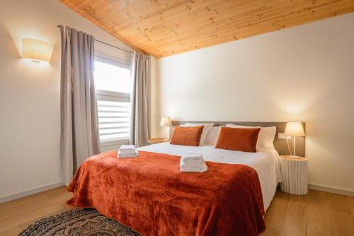 a bedroom with a bed with a large window at APG Carrer Nou Atic in Girona