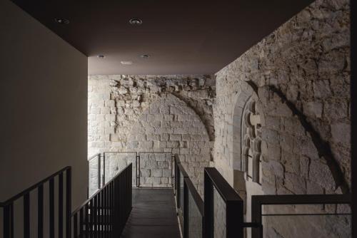 a staircase in a building with a stone wall at APG Carrer Nou Atic in Girona