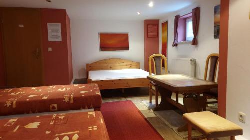 a room with a bed and a desk and a table at Zimmervermietung Koltermann in Greifswald