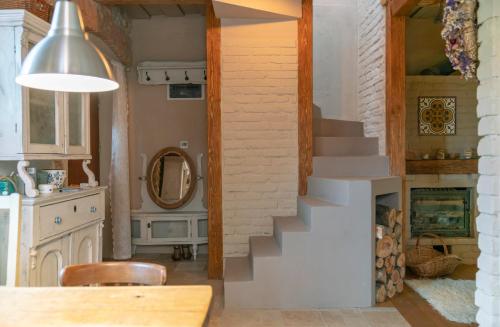 a living room with a staircase and a fireplace at Koloska House in Balatonfüred