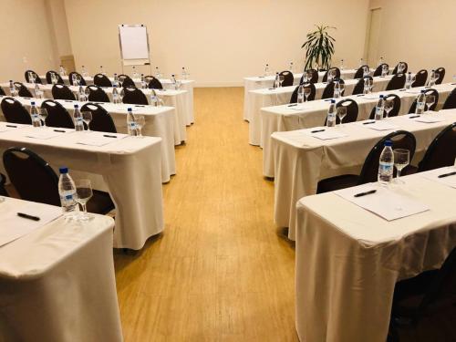 a room full of tables and chairs with white table cloth at Viale Tower Hotel in Foz do Iguaçu