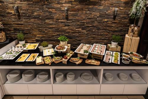 a buffet of food on a table in a restaurant at Kormoran Medispa in Rowy