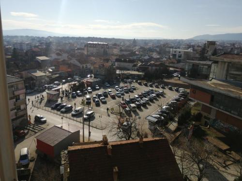 a parking lot with parked cars in a city at Apartman DUNJA in Vranje