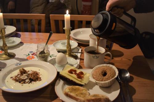 a person taking a picture of a table with food at Ekologiska Fru Gran B&B i Tiveden in Gårdsjö
