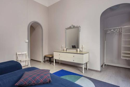a bedroom with a bed and a dresser and a mirror at Two Rooms Bellini in Catania